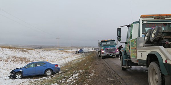 tow trucks recovering a vehicle that slide off a road